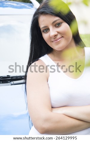 Young Attractive woman in her car, smiling holding her keys