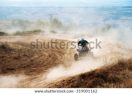 Man on the Quad Rides Fast Along the Dusty Road