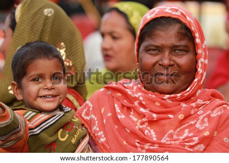 JAIPUR, INDIA Ã¢Â?Â? MARCH 4: An unidentified child held by his mother outside the City Palace on March 4, 2012 ahead of the annual Holi Festival in Jaipur, Rajasthan, Northern India.