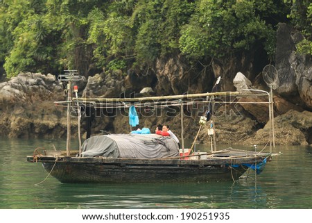 Halong Bay, Vietnam, April 10 2014: Fishing boat in Halong Bay used predominantly to supply the local floating villages. Halong Bay is a UNESCO World Heritage Site.