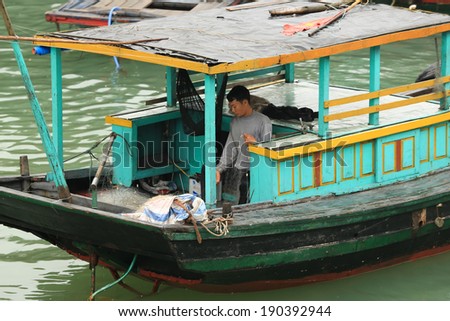 Halong Bay, Vietnam, - April 10, 2014: Fishing boat in Halong Bay used predominantly to supply the local floating villages. Halong Bay is a UNESCO World Heritage Site.
