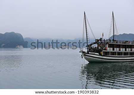 Halong Bay, Vietnam - April 10, 2014: Junk boat in Halong Bay used predominantly as tourist sight-seeing boats. Halong Bay is a UNESCO World Heritage Site and a prime travel destinations in Vietnam.
