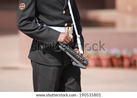New Delhi, India - February 25, 2012: Armed security guard at The India Gate in New Delhi, National Capital Region, North India. The India Gate was designed by Edwin Lutyens.