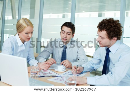 Business people gathered to discuss documents