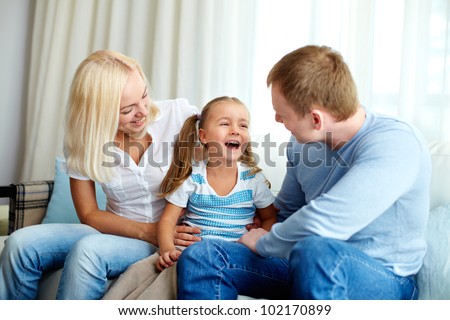 Portrait of happy daughter laughing and looking at her father