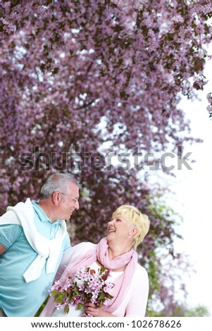Mature couple looking at one another in blooming garden