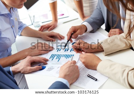 Image of human hands over business documents at meeting
