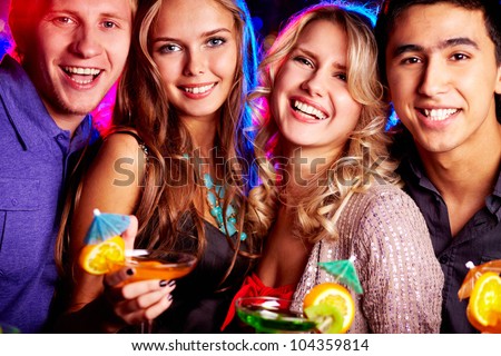 Group of cheerful friends having fun at party