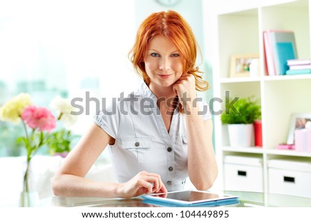 Portrait of an adorable woman with flirty look smiling at camera