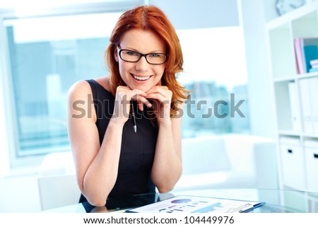 Successful business woman laughing at camera