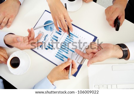Close-up of a business team discussing graphs and charts