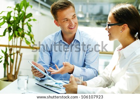Smiling consultant preferring modern technology to obsolete forms of doing business