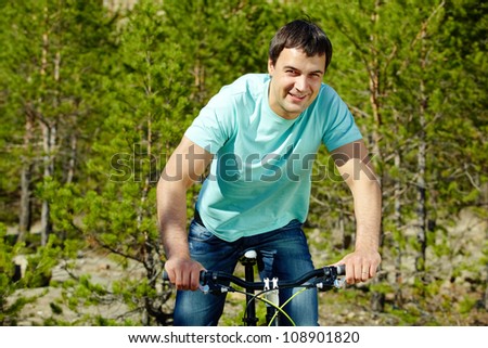 Portrait of a handsome man riding a bike
