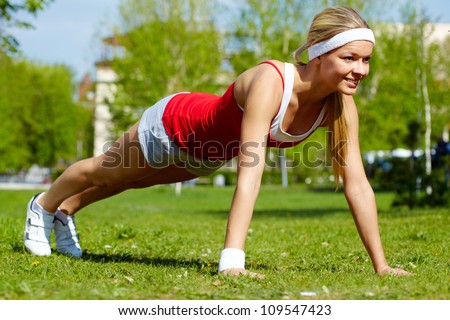 Portrait of a young woman doing physical exercise in natural environment
