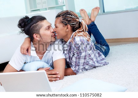 Image of young guy and his girlfriend having rest at home