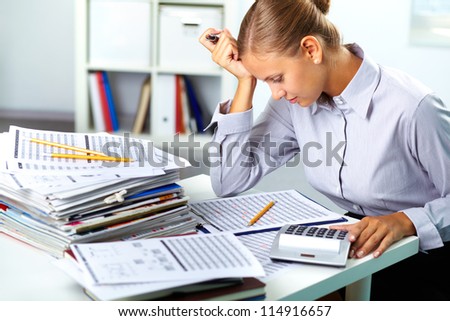 Portrait of a young businesswoman working with papers in office