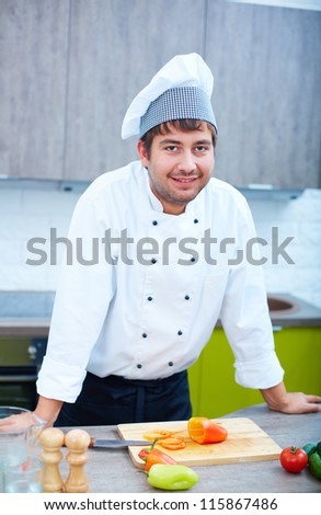 Portrait of handsome man in cook uniform looking at camera