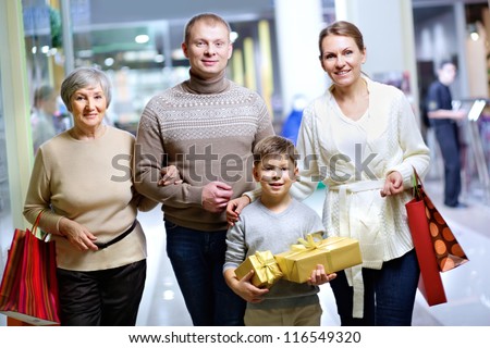 Portrait of happy family during shopping in the mall before Christmas