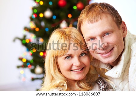 Portrait of happy husband and wife looking at camera