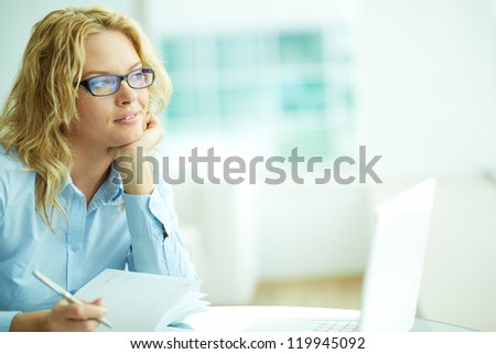 Portrait of smart businesswoman thinking during work