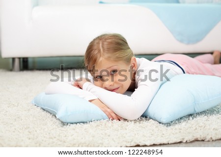 Portrait of lovely girl lying on the floor at home