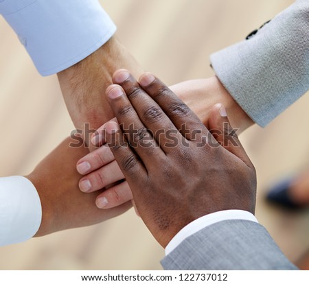 Above angle of pile of hands of business partners