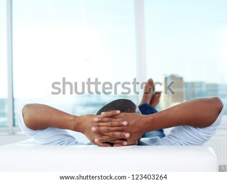 Image Of Young African Man Lying On Sofa And Having Rest