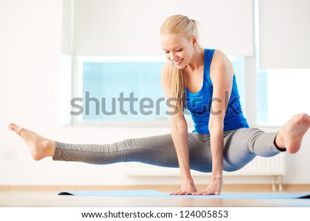 Portrait of young woman doing physical exercise in gym