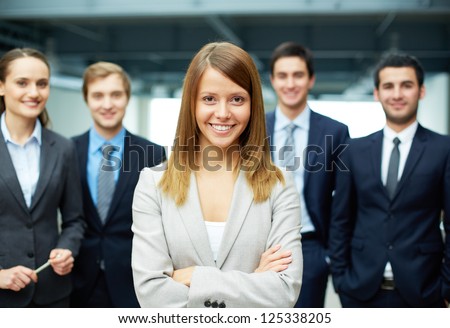 Group Of Friendly Businesspeople With Happy Female Leader In Front