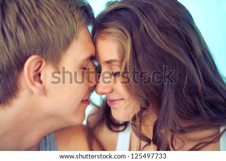 Young couple touching by their faces