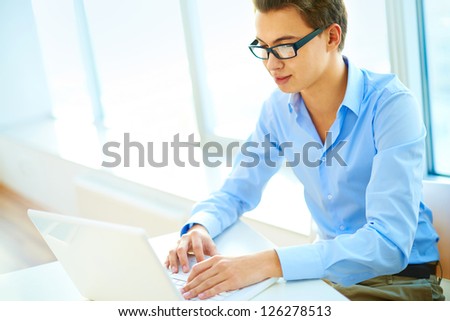 Image of a smart guy working on his laptop