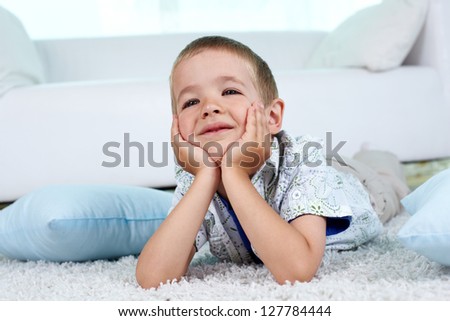Adorable child lying on the floor at home on weekend