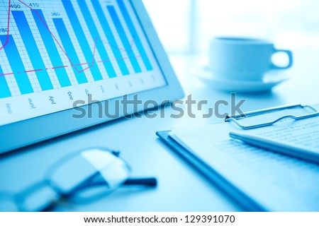 Image of workplace with paper and electronic documents on desk