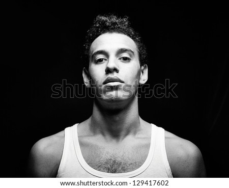 Portrait of handsome guy in vest looking at camera