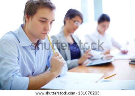 Portrait of group of students making notes or writing test