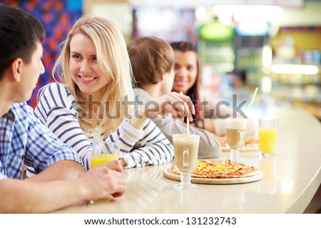 Image of teenage couple interacting in cafe Image of teenage couple interacting in cafe