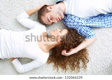 The above view of young lovers lying face to face
