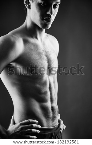 Black-and-white shot of a shirtless guy with muscular body