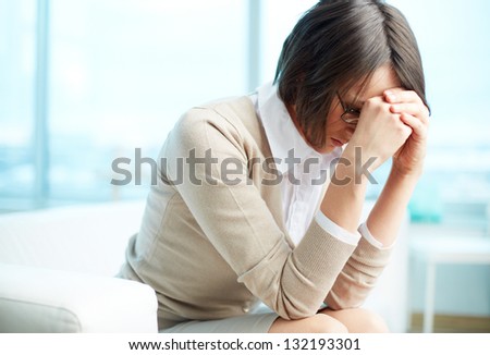 Portrait Of Tired Woman Touching Her Head
