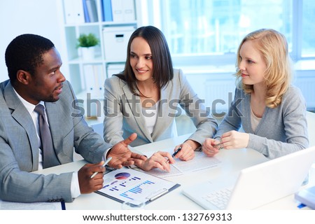 Pretty business interns listening to their team leader