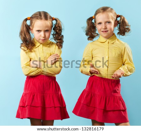 Portrait of twin girls with opposite emotions