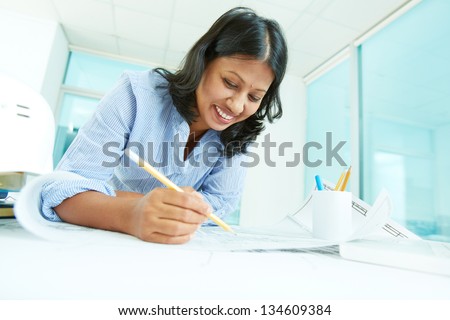 Portrait of mature businesswoman working with papers in office