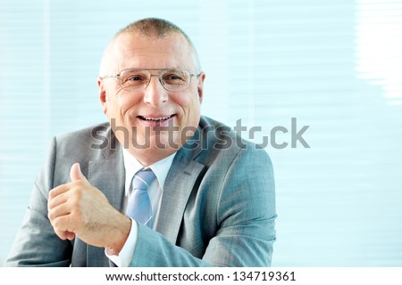 Portrait of elderly businessman in suit and eyeglasses