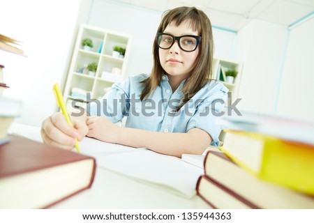 Portrait of an excellent female student sitting at desk