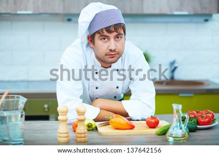 Portrait of handsome man in cook uniform looking at camera