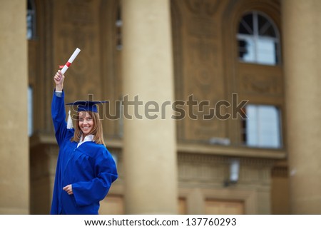 Portrait of lovely student with graduation certificate looking at camera