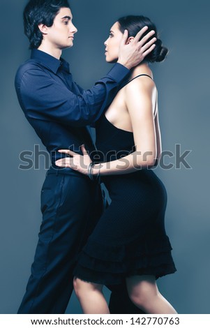 Portrait of elegant couple on black background