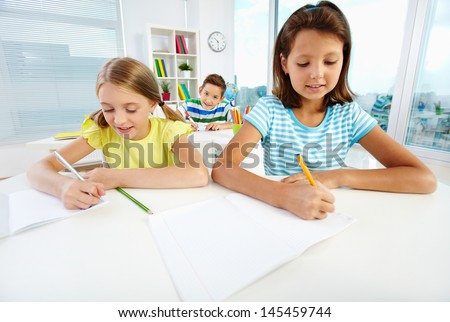 Diligent pupils being busy doing their schoolwork