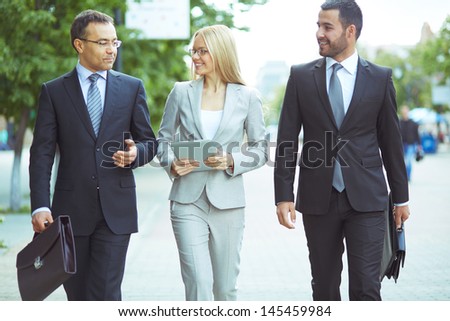Image of a perfectly combined business team with two confident men and a lovely lady