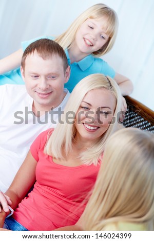 Portrait of parents and children talking at home during rest